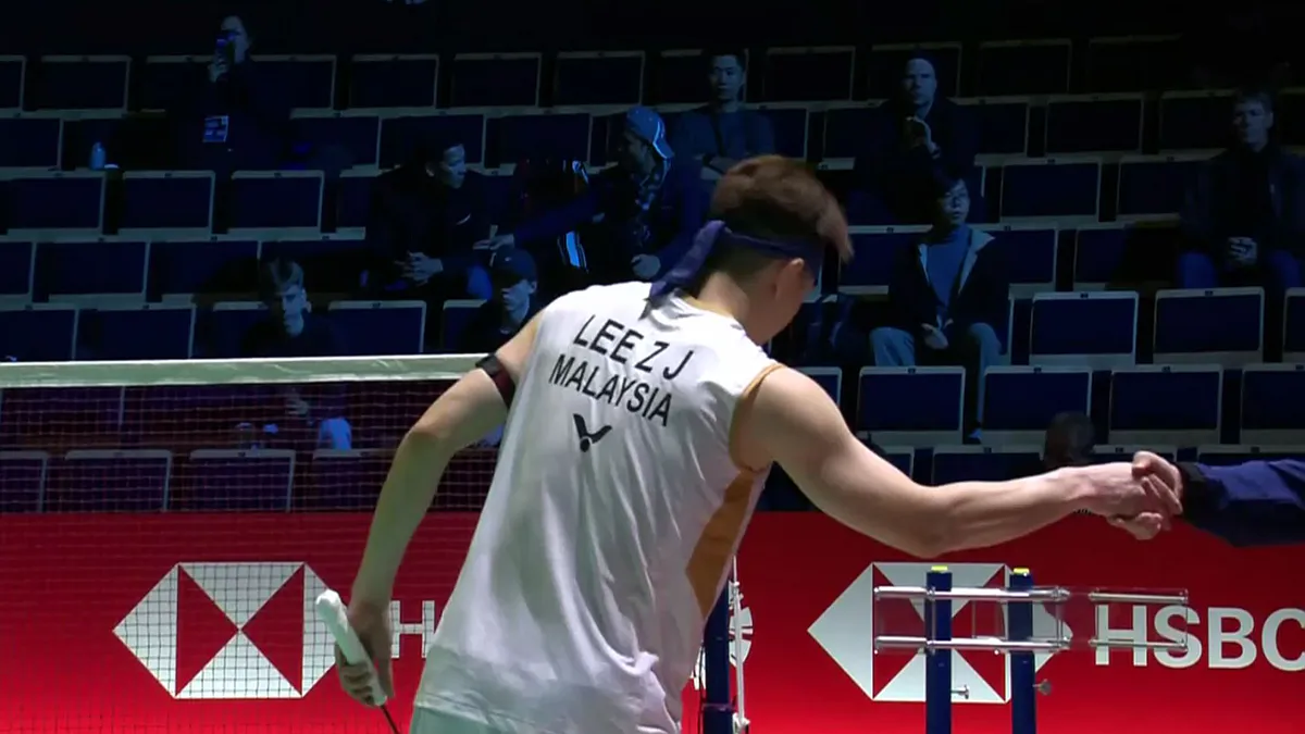 Badminton racket and shuttlecock on an indoor court
