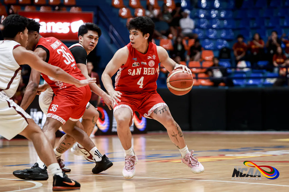 Basketball and hoop inside an indoor sports arena