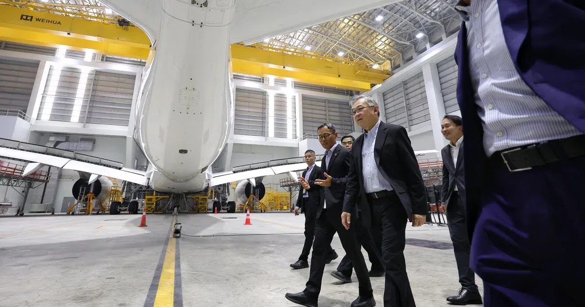 Wide-body aircraft inside an aircraft maintenance hangar