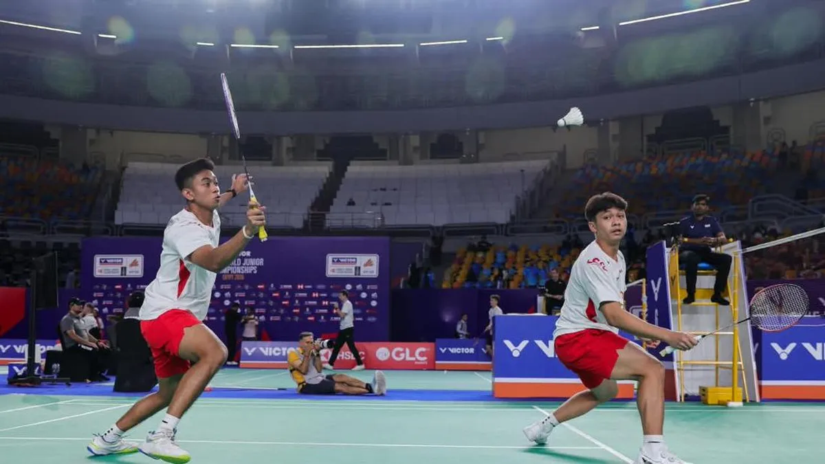 Shuttlecock and badminton racket beside an indoor court