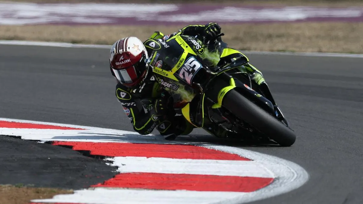 Racing motorcycles on a circuit with trackside kerbs