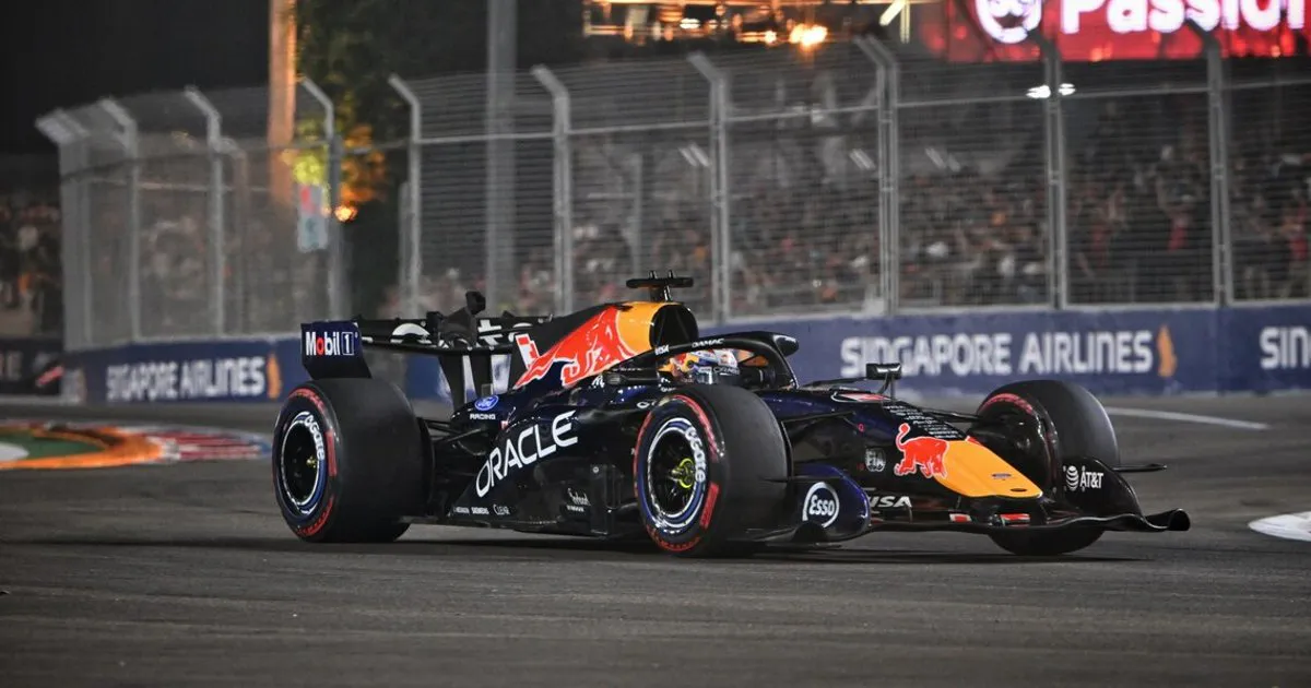 Formula 1 cars on an illuminated street circuit at night