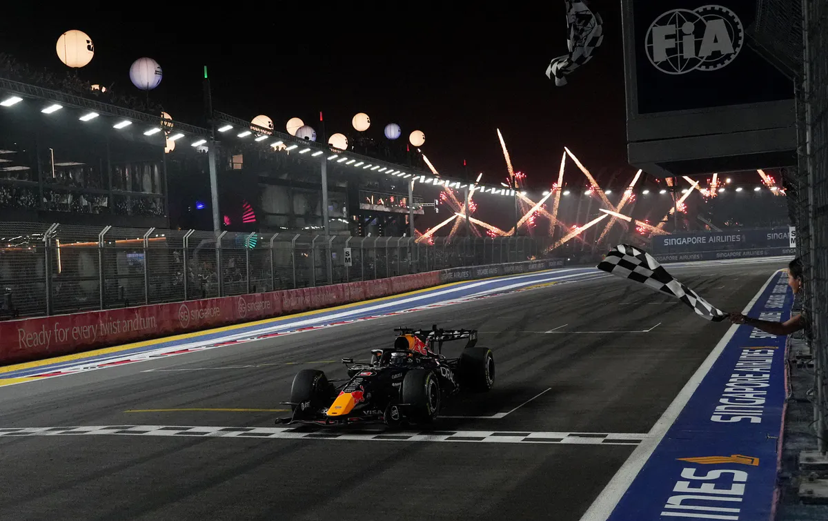 Formula 1 racing cars on a floodlit street circuit