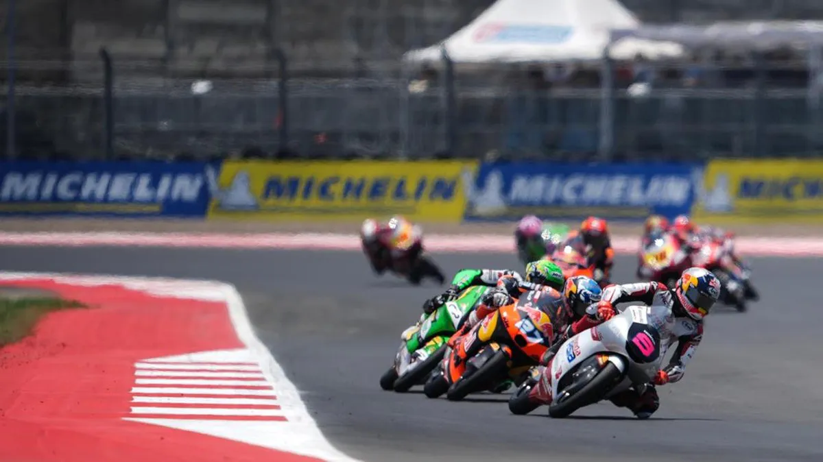 Racing motorcycles on a circuit with trackside kerbs