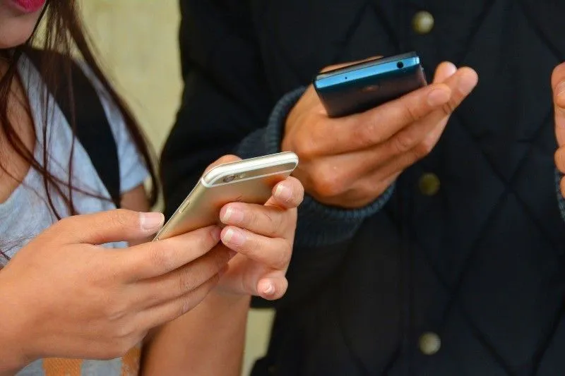 Mobile phones arranged on a neutral tabletop