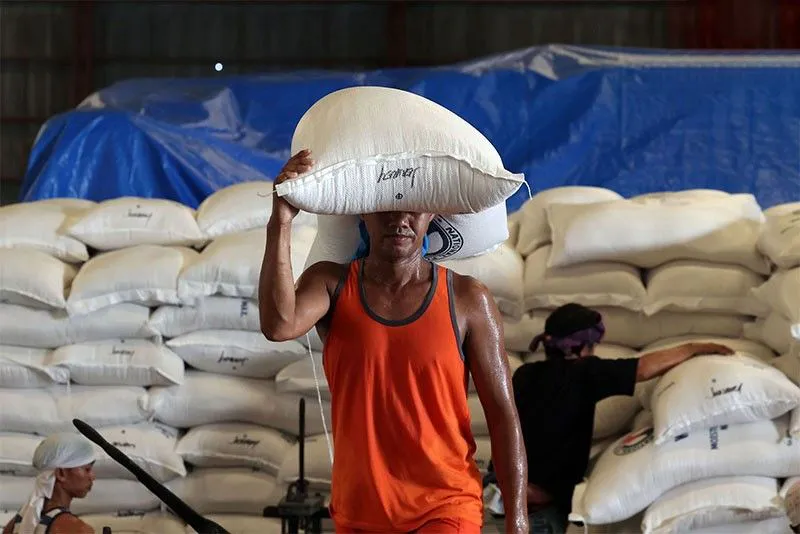 Sacks of rice stacked inside a warehouse