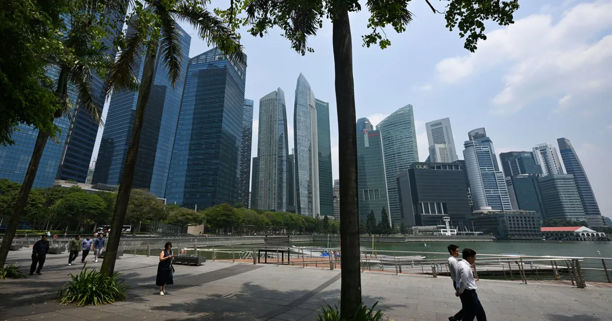 Singapore skyline with commercial buildings and construction cranes