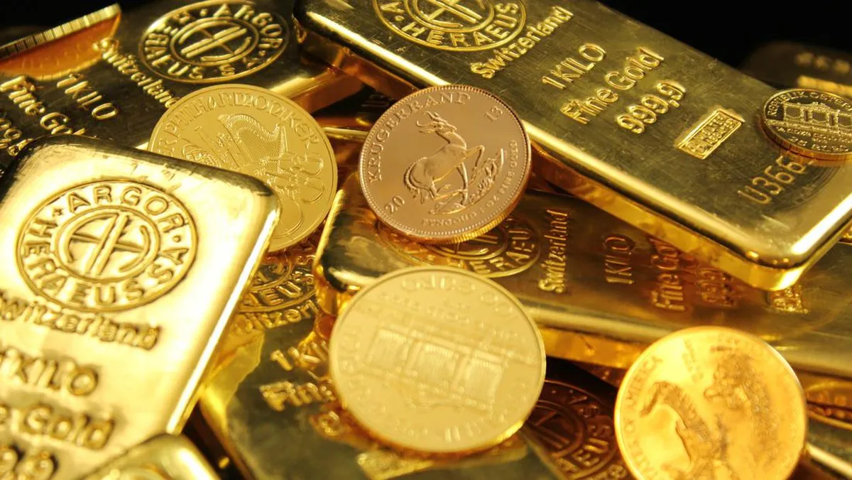 Gold bars and jewellery on a display surface