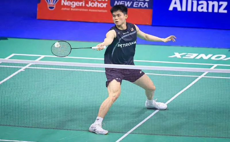 Badminton racket and shuttlecock beside a court