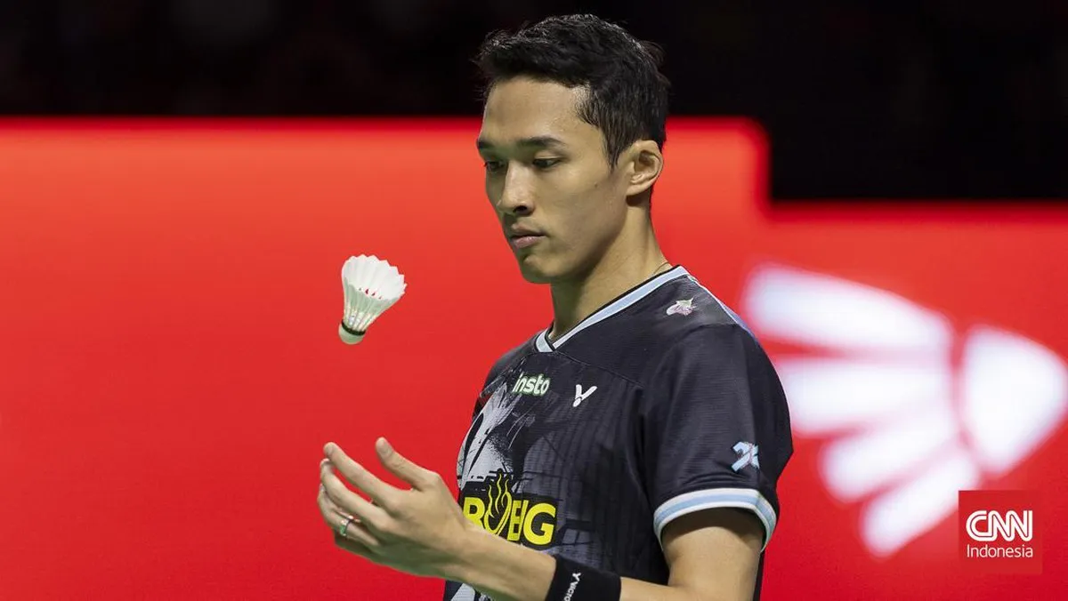 A badminton racket and shuttlecock beside a court
