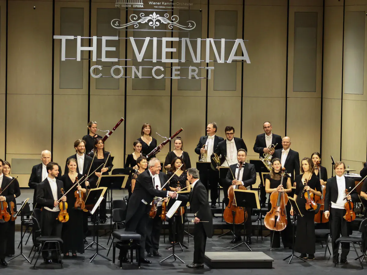 Chairs and music stands arranged for a chamber orchestra on a concert stage