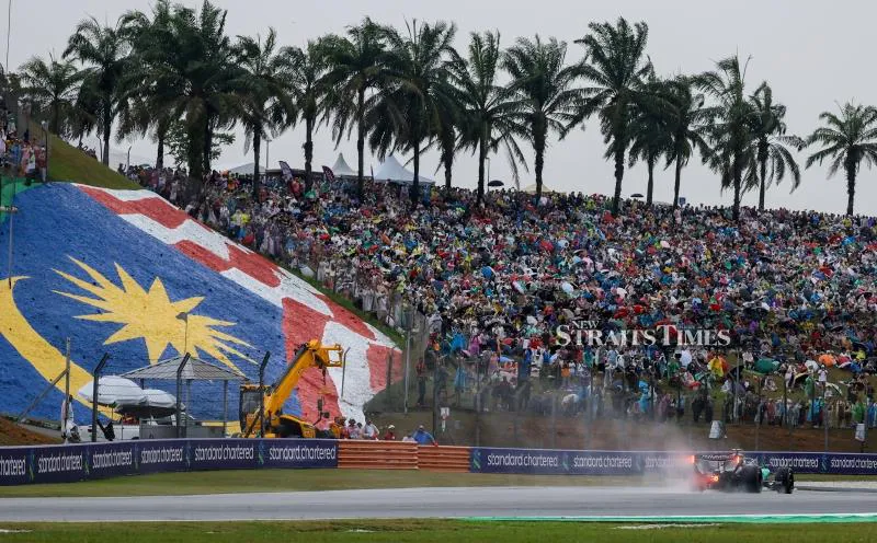 A motorsports circuit with grandstands and a pit lane