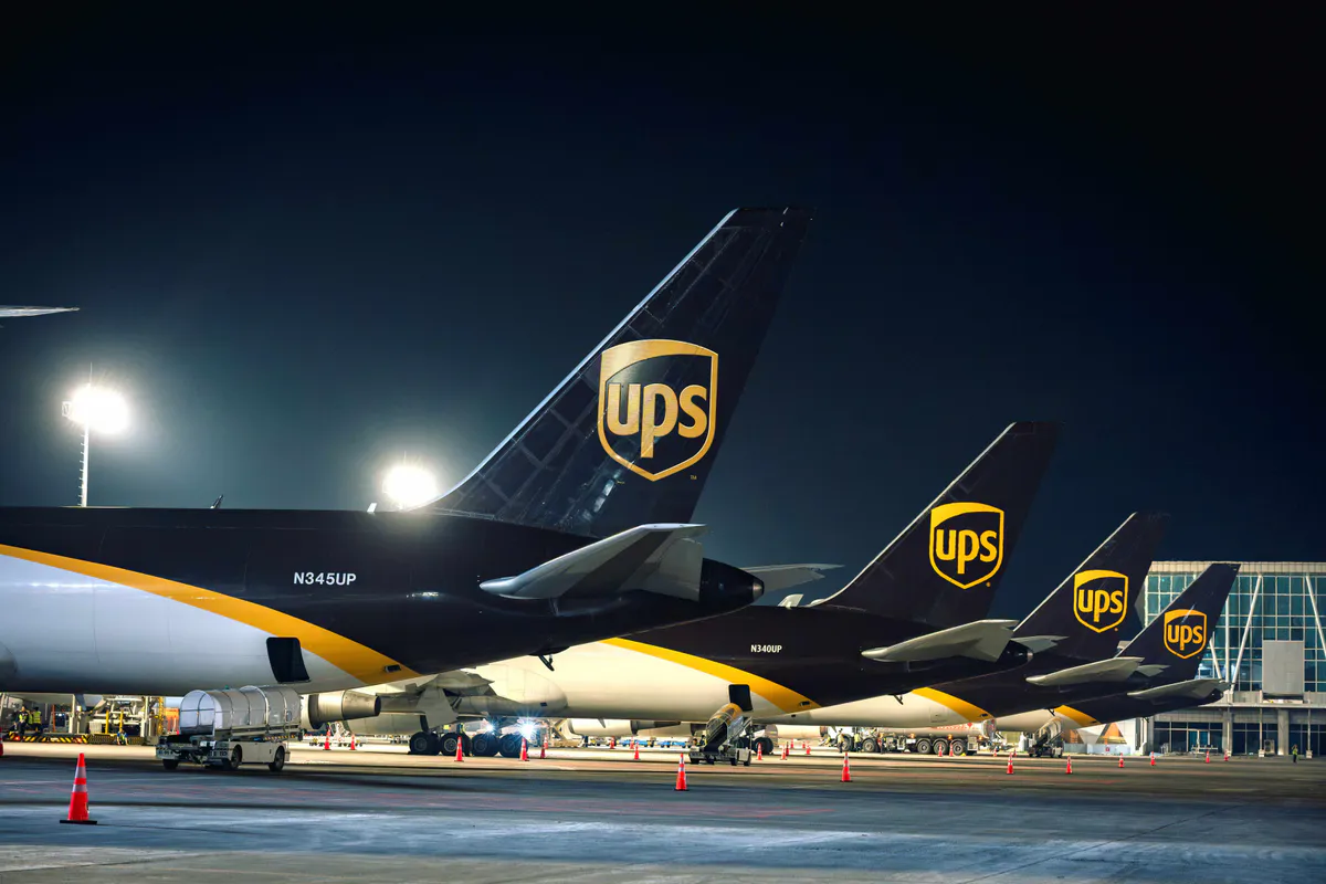 Packages moving along conveyor belts inside a logistics warehouse