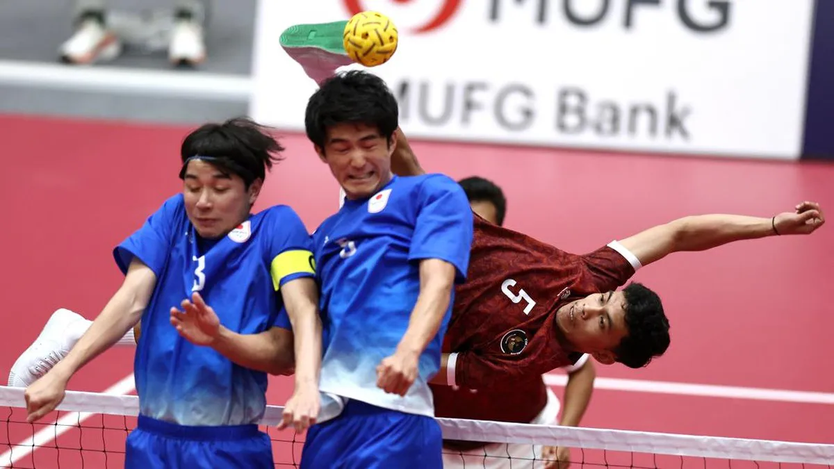 A sepak takraw ball beside a court net