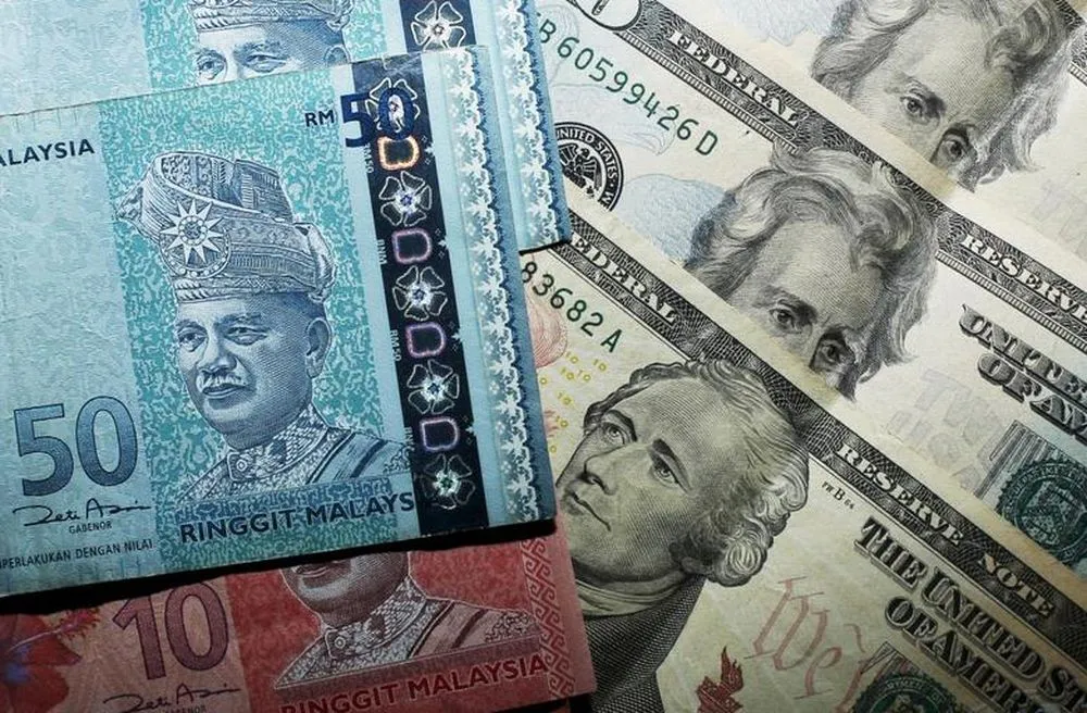 Malaysian ringgit banknotes alongside US dollar notes