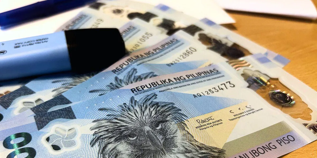 Philippine peso banknotes alongside US dollar notes