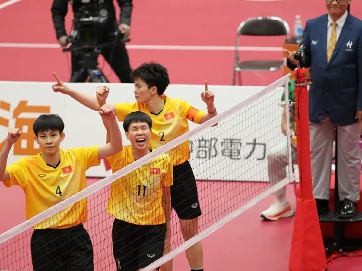 A sepak takraw ball beside a court net