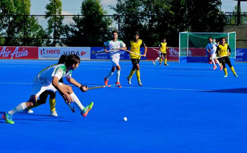 Hockey sticks and a ball on an artificial turf pitch