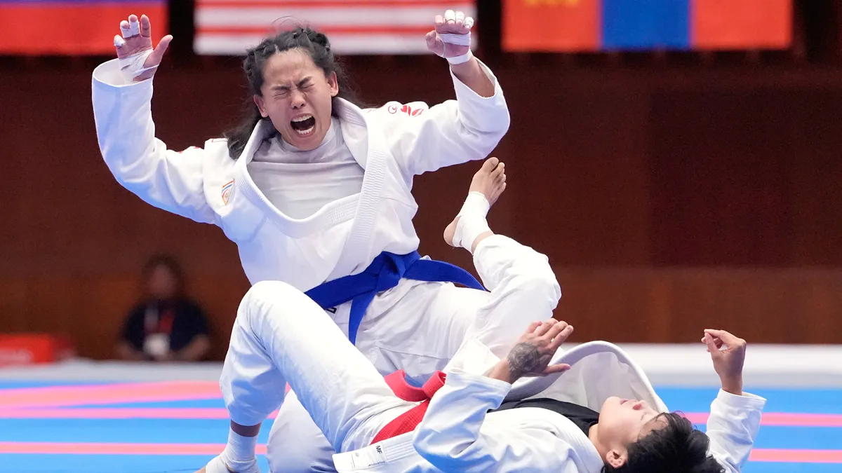 A martial arts competition mat inside an indoor sports hall