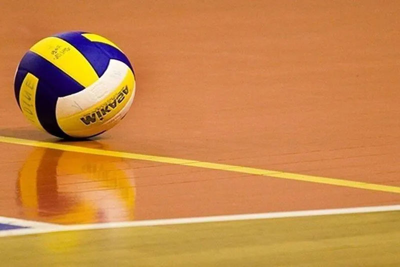 Volleyball net and ball on an indoor court