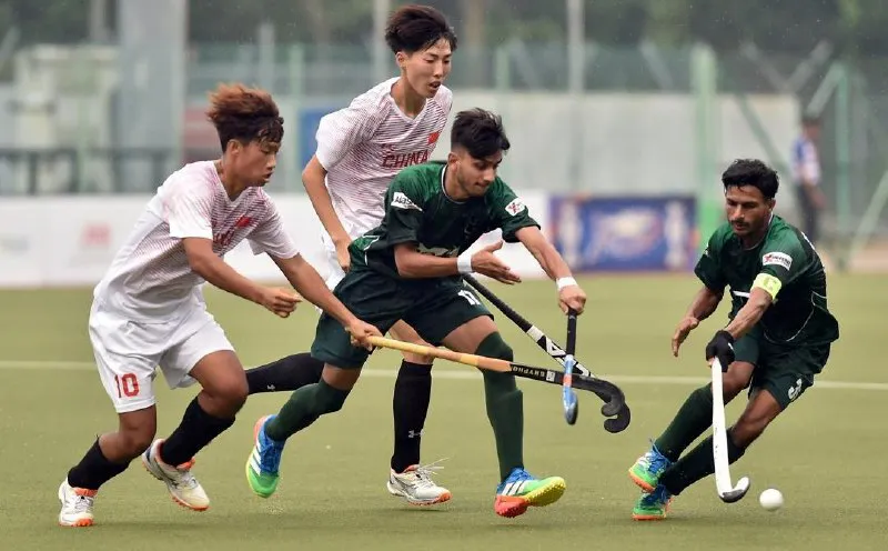 Hockey sticks and a ball on an artificial turf pitch