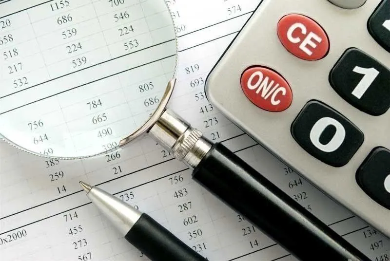 Tax forms and a calculator on an office desk