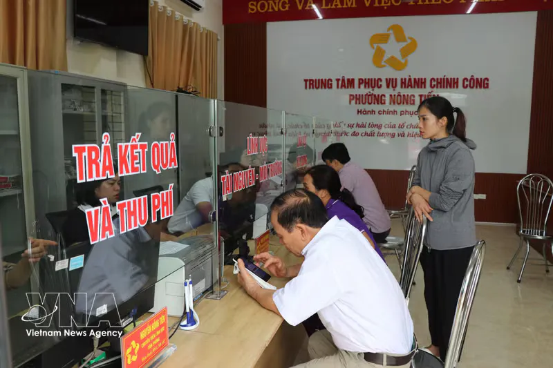Smartphone beside a computer keyboard at a public service counter