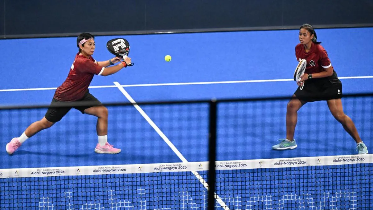 Padel rackets and balls beside a court net