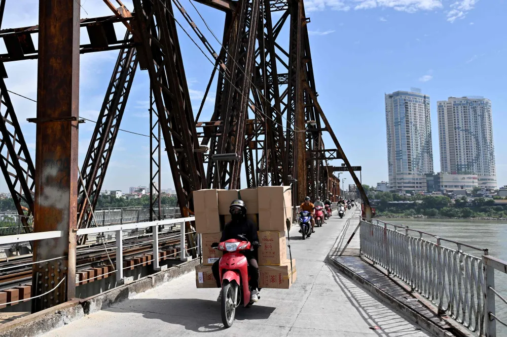 Motorbikes and goods traffic on a bridge in Hanoi