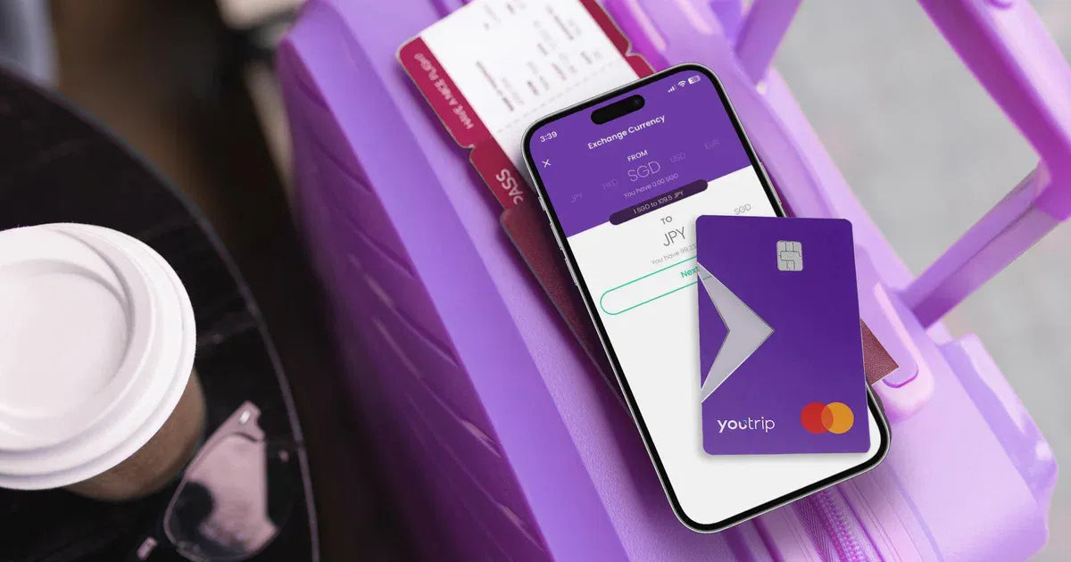 Smartphone and payment card beside a wallet