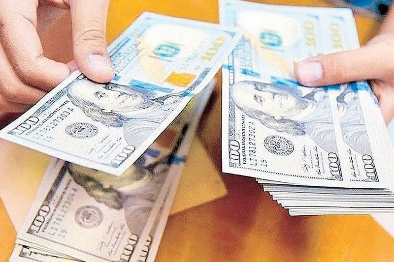 Philippine peso banknotes beside US dollar banknotes