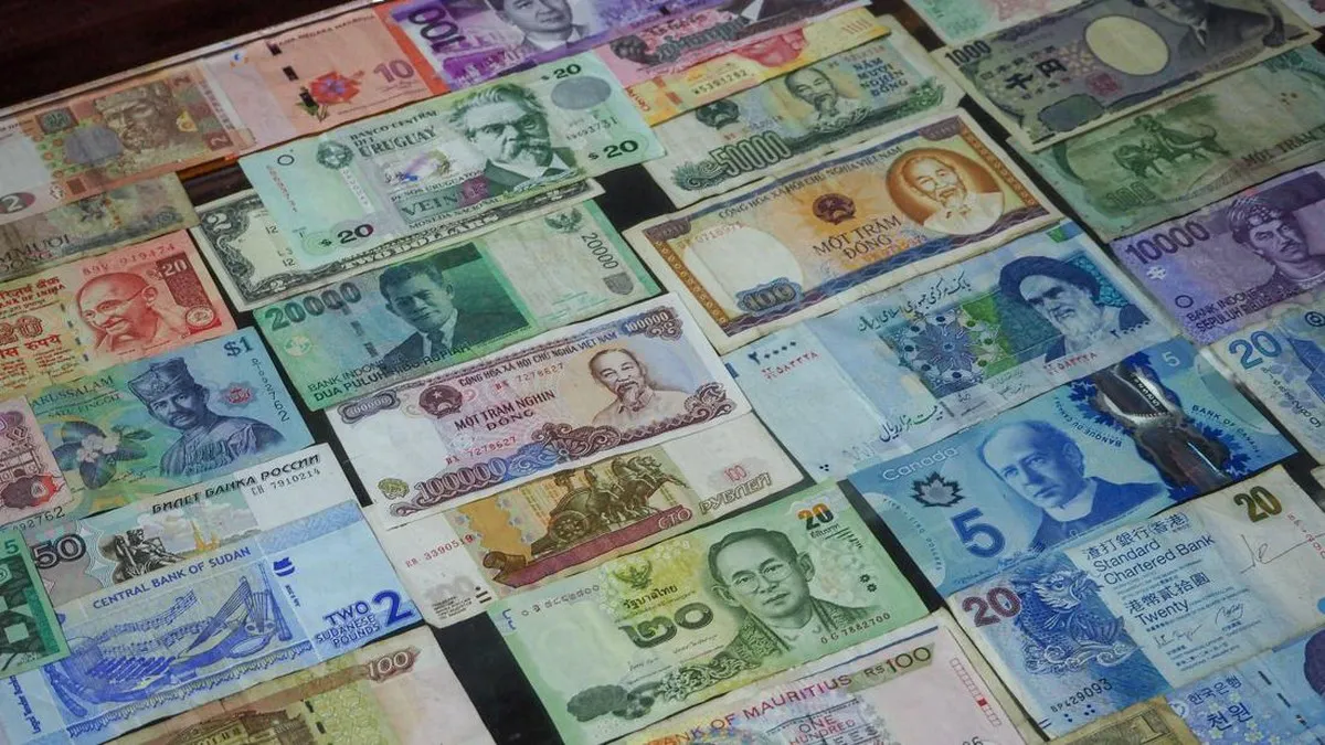 Indonesian rupiah banknotes beside US dollar notes