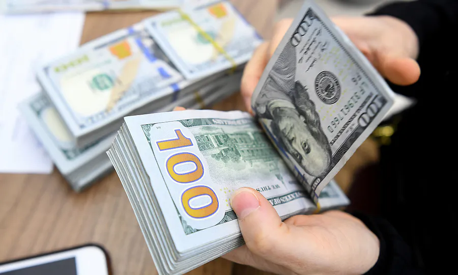 US dollar banknotes on a bank counter