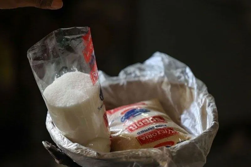 Bags of sugar displayed at a market stall