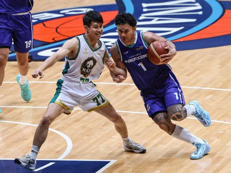 Basketball on an indoor court beneath a hoop