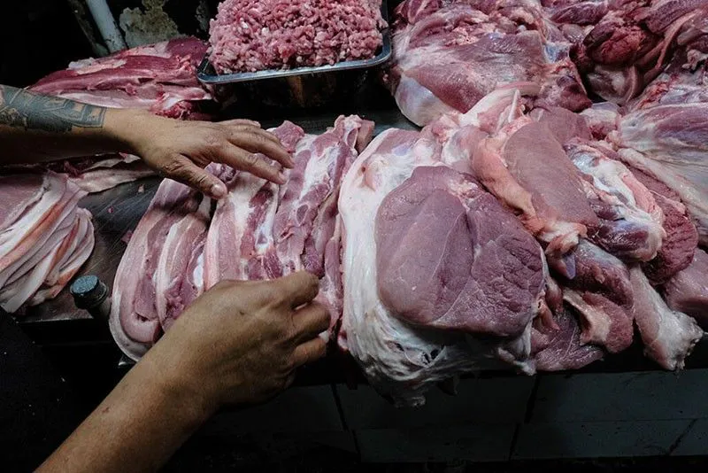 Pork cuts displayed at a market stall