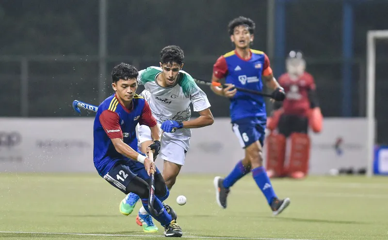Hockey sticks and a ball on an artificial turf pitch