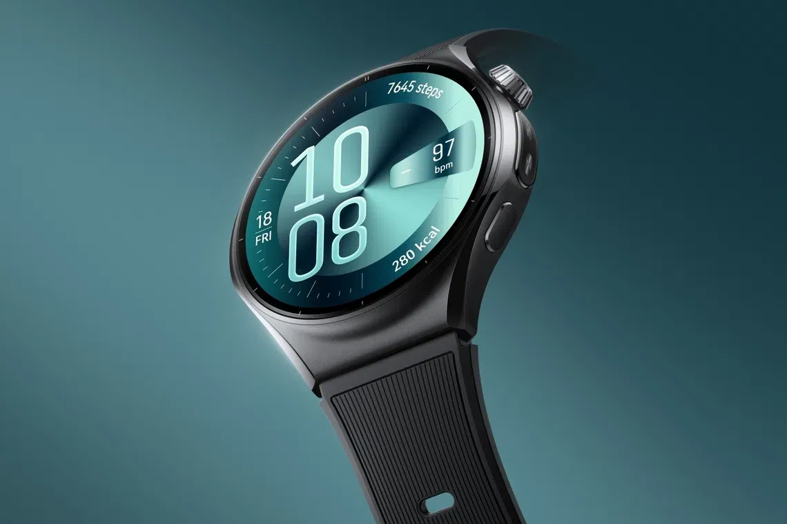 Smartwatch with a circular display and strap on a neutral background