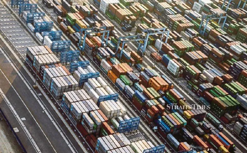 Shipping containers and cargo cranes at a port terminal
