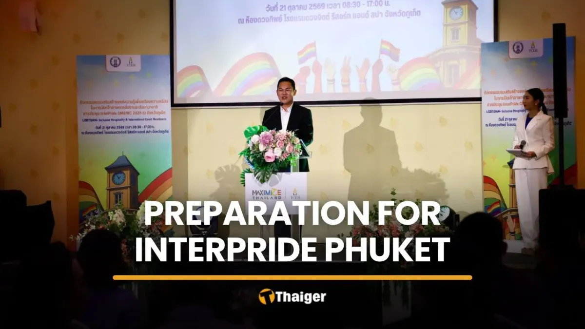 Conference hall with rows of seats and rainbow flags
