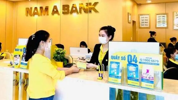 Vietnamese dong banknotes beside financial documents