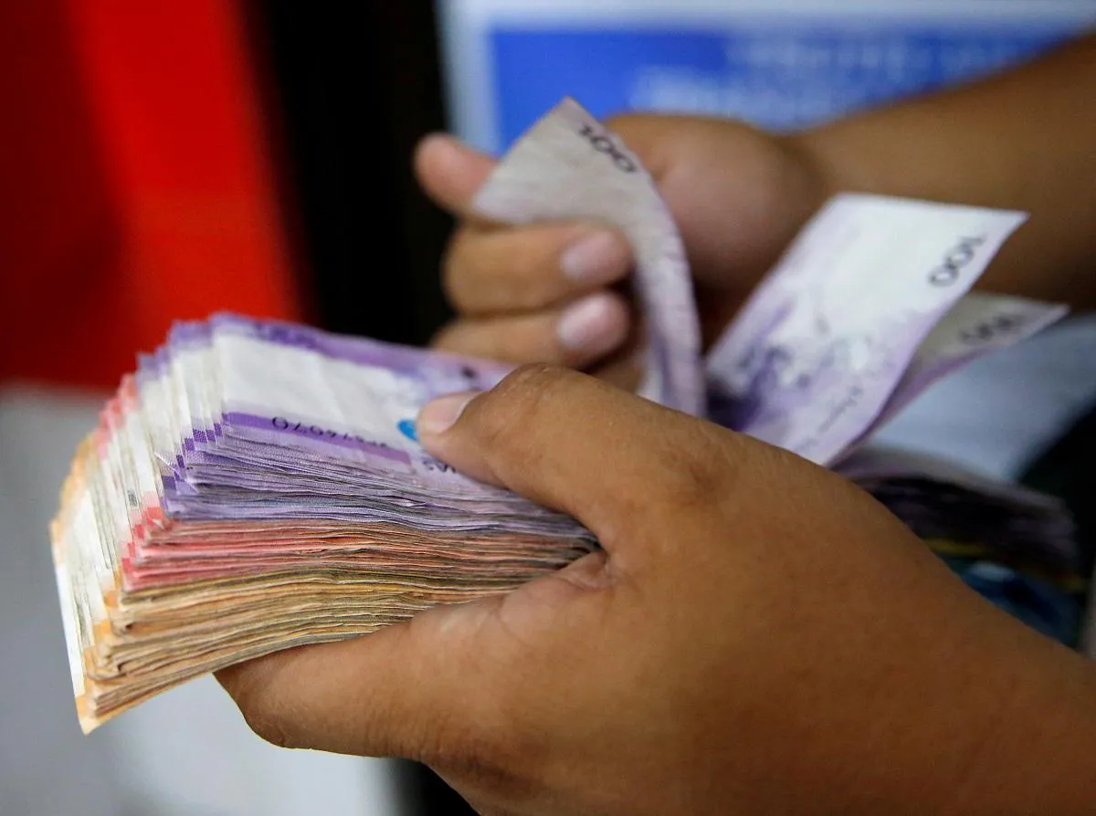 Philippine peso banknotes beside US dollar banknotes