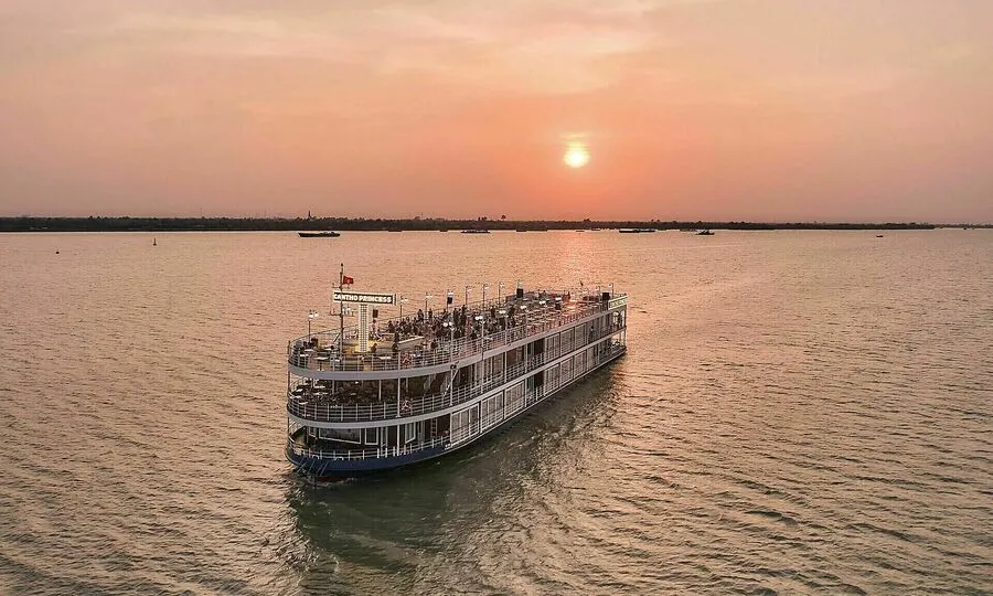 A cruise boat travelling along a river in Vietnam