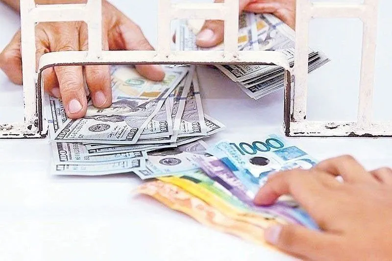 Philippine peso banknotes beside US dollar banknotes