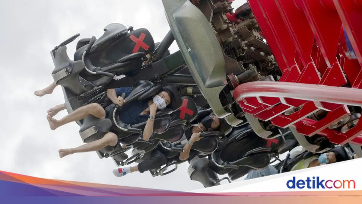 Amusement park rides and water slides under cloudy skies