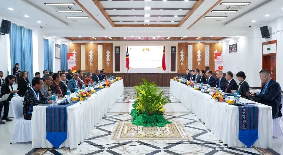 Conference table with microphones and documents arranged for bilateral talks