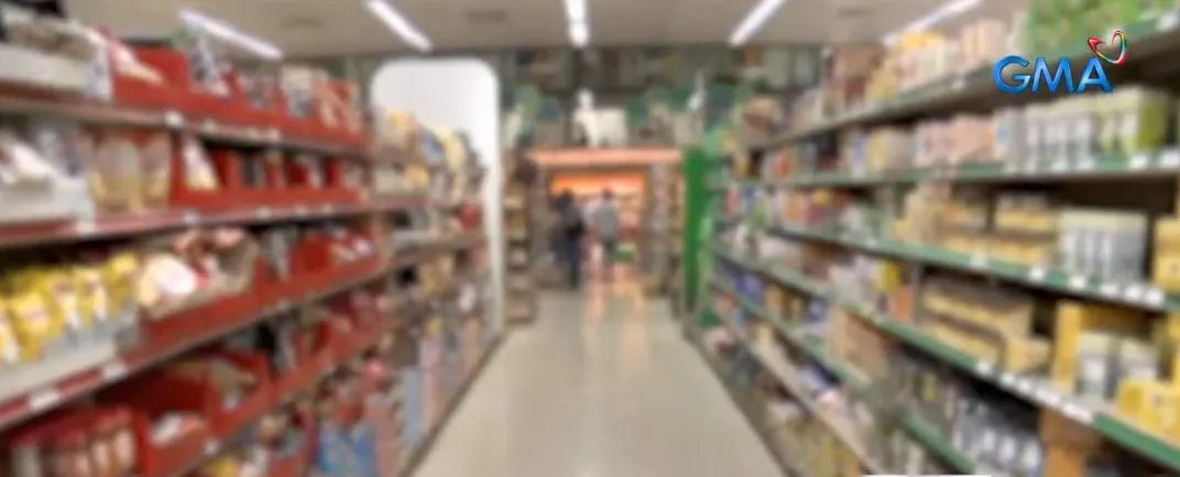 Packaged groceries and price labels on supermarket shelves