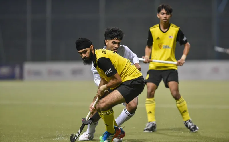 Hockey sticks and a ball on an artificial turf pitch