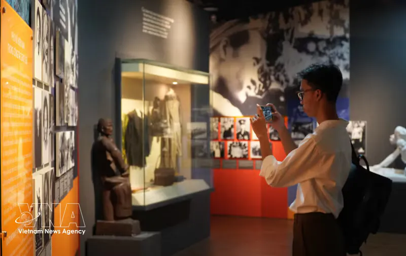 Museum display cases with historical artefacts and a digital information screen