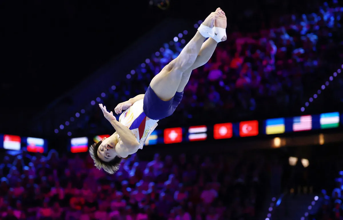 A floor exercise mat inside a gymnastics arena